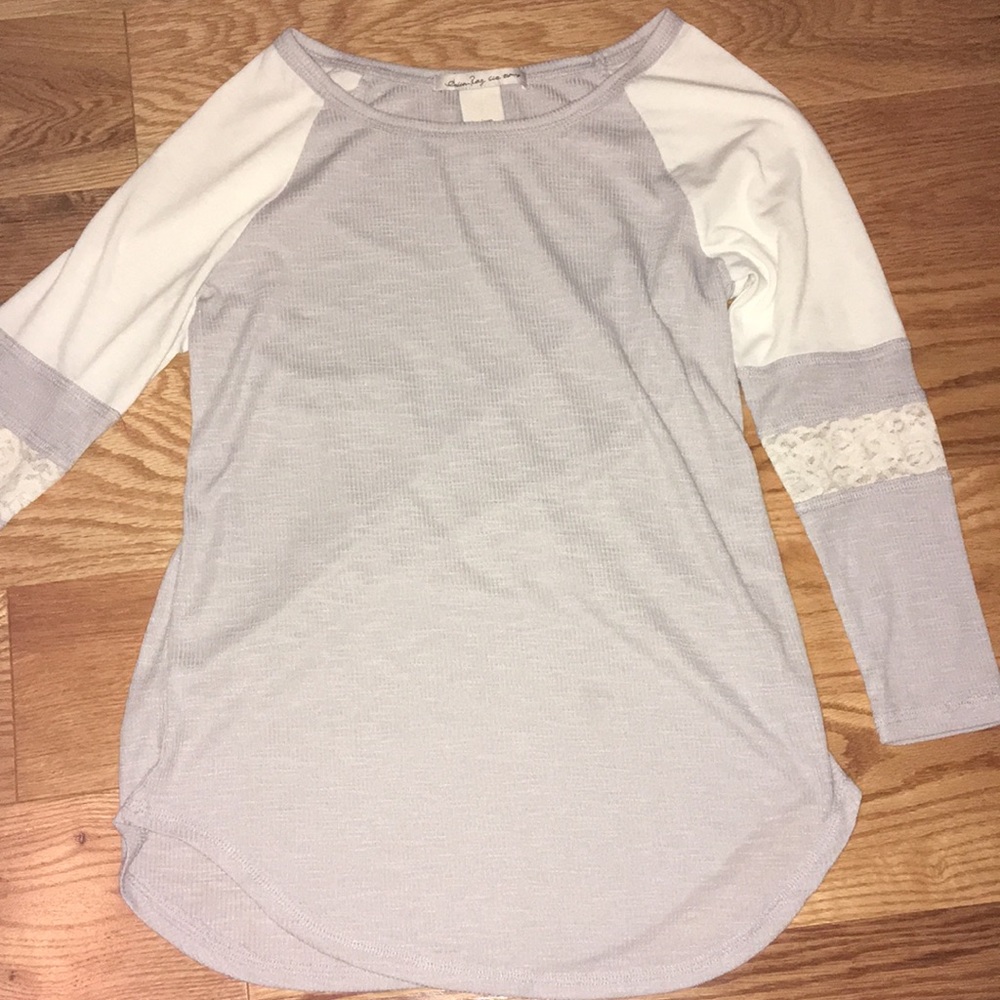 gray and white shirt with lace on the sleeves